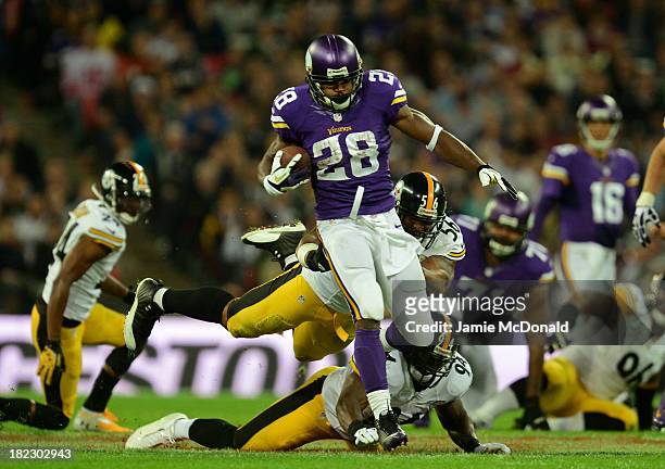 Running back Adrian Peterson of the Minnesota Vikings beats outside linebacker LaMarr Woodley of the Pittsburgh Steelers and inside linebacker...