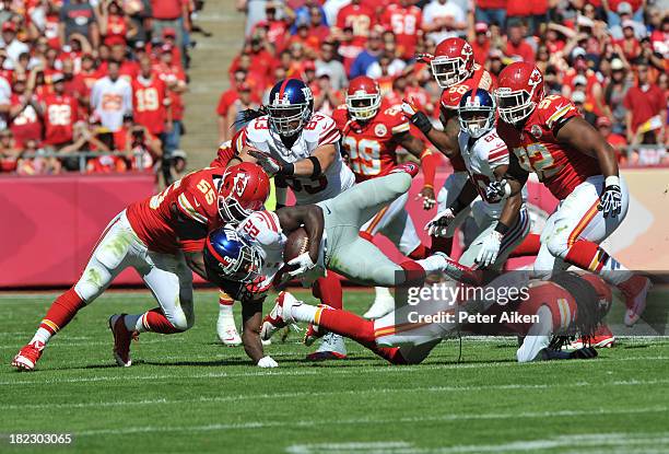 Linebacker Keith Rivers of the Kansas City Chiefs tackles running back David Wilson of the New York Giants during the first half on September 29,...