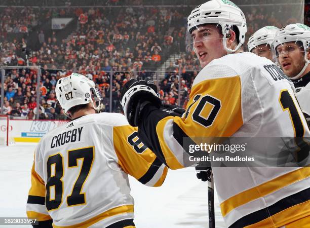 Sidney Crosby of the Pittsburgh Penguins celebrates his first period goal against the Philadelphia Flyers with teammate Drew O'Connor and other...