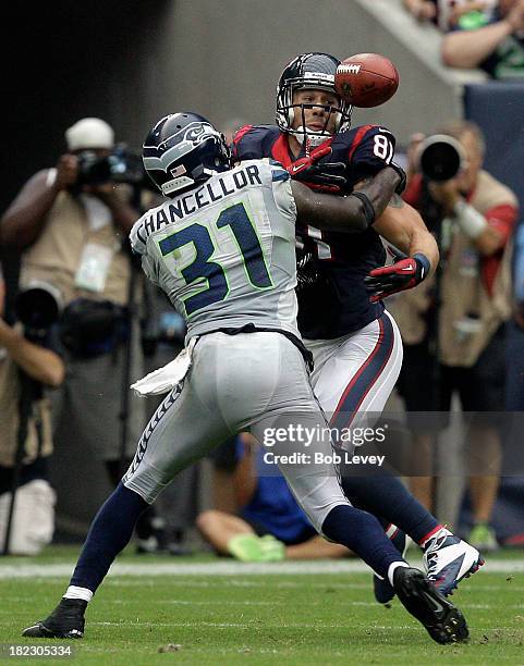 Kam Chancellor of the Seattle Seahawks breaks up a pass inntended for Owen Daniels of the Houston Texans that resulted in an interception for the...