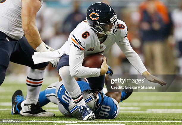Ndamukong Suh of the Detroit Lions brings down Jay Cutler of the Chicago Bears at Ford Field on September 29, 2013 in Detroit, Michigan.