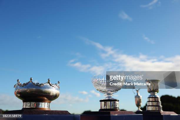 The ISPS HANDA Australian Open Men's, Woman's and All Abilities trophies and the Claret Jug are seen on a plinth during the ISPS HANDA Australian...
