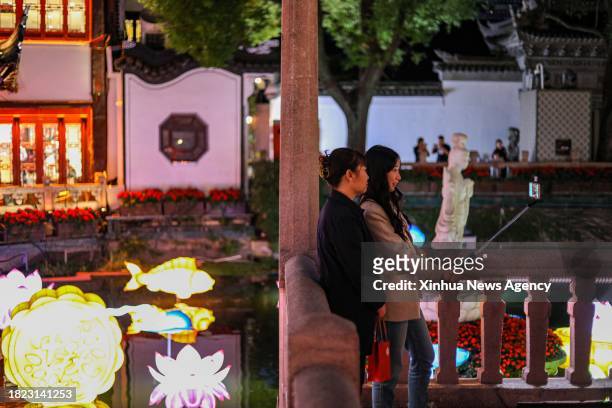 This photo taken on Oct. 11, 2023 shows tourists posing for pictures at Yuyuan Garden in east China's Shanghai. Yuyuan Garden, a cultural beacon of...