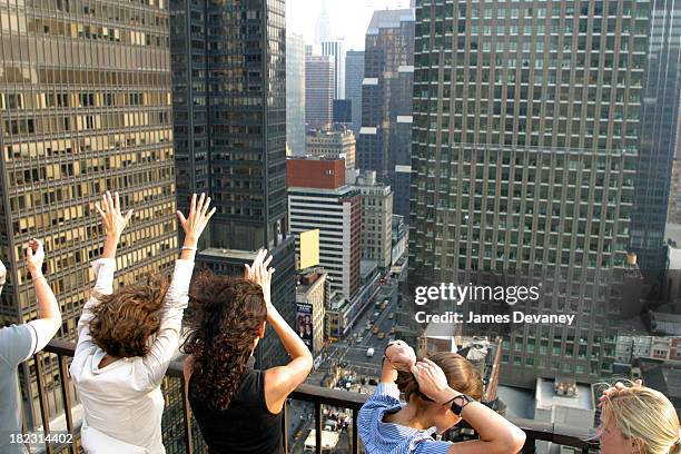 Fans of the Dave Matthews Band gather atop a midtown apartment building overlooking the Ed Sullivan Theatre where the band performed.