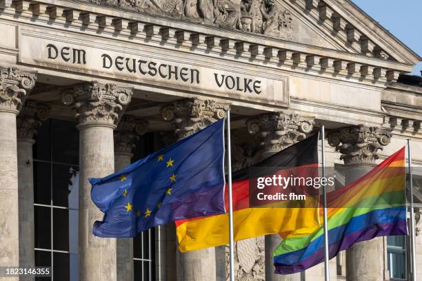 deutscher bundestag - the reichstag building with eu-, german- and lgbtq+ - flags (german parliament building) - berlin, germany - berlin gay pride stock pictures, royalty-free photos & images