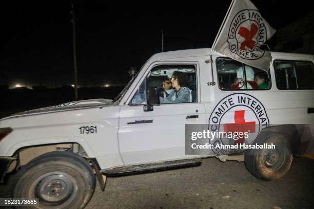 Hostages are transported in International Committee of the Red Cross vehicles from the Gaza Strip through the Rafah land crossing on November 30,...
