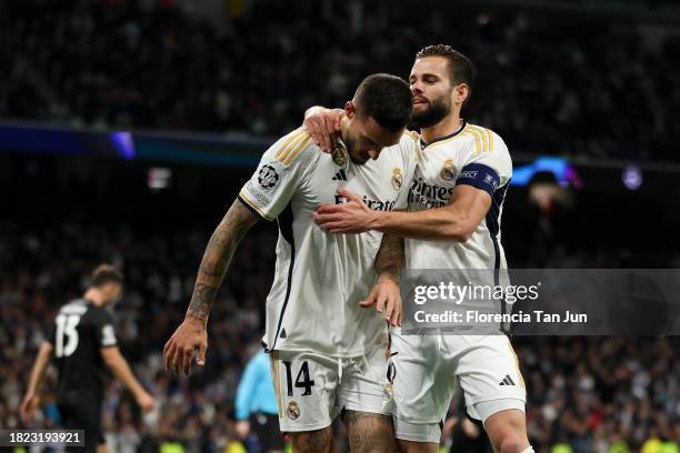 Joselu of Real Madrid celebrates with Nacho Fernandez of Real Madrid CF after scoring the team's fourth goal during the UEFA Champions League match...