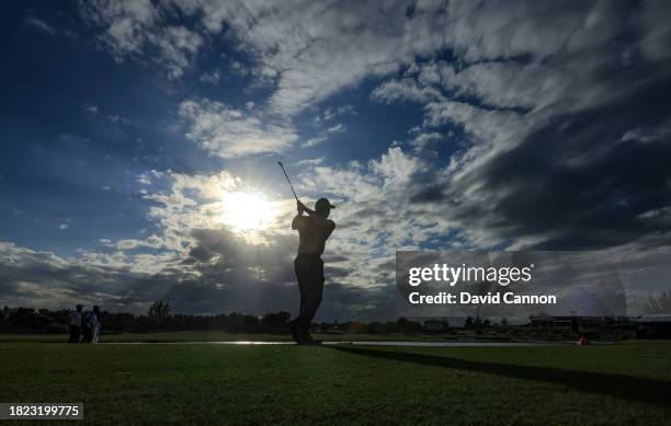 Tiger Woods of The United States plays his second shot on the 18th hole during the first round of the Hero World Challenge at Albany Golf Course on...