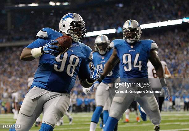 Nick Fairley of the Detroit Lions celebrates a third quarter touchdown with Ezekiel Ansah while playing the Chicago Bears at Ford Field on September...