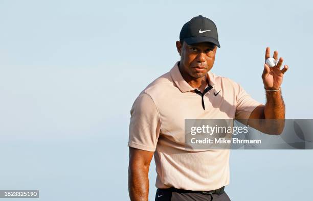 Tiger Woods of the United States reacts to a putt on the 18th hole during the first round of the Hero World Challenge at Albany Golf Course on...