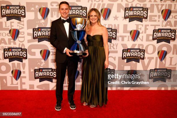 Cup Series driver, Christopher Bell poses for photos with the Busch Light Pole Award trophy on the red carpet prior to the NASCAR Awards and Champion...