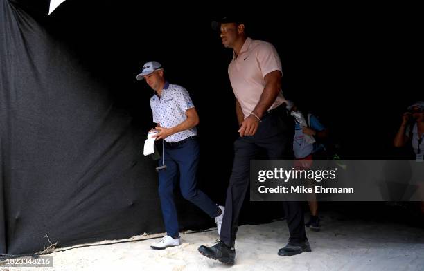 Tiger Woods and Justin Thomas of the United States walk to the 10th hole during the first round of the Hero World Challenge at Albany Golf Course on...