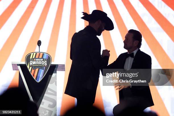 Fighter Donald "Cowboy" Cerrone welcomes retired NASCAR Cup Series driver Kurt Busch onstage during the NASCAR Awards and Champion Celebration at the...