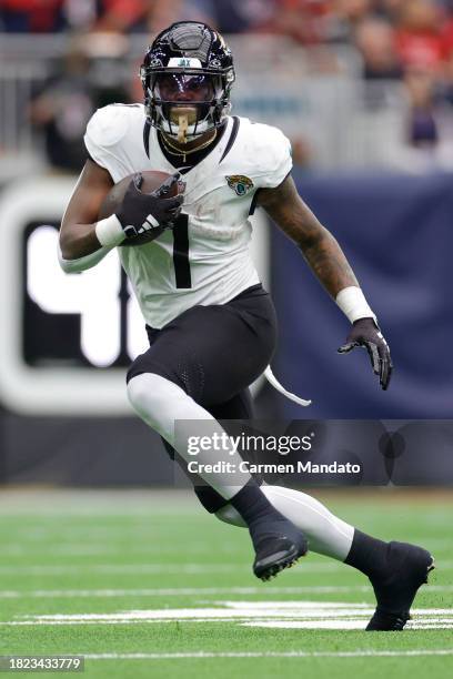 Travis Etienne Jr. #1 of the Jacksonville Jaguars in action against the Houston Texans at NRG Stadium on November 26, 2023 in Houston, Texas.