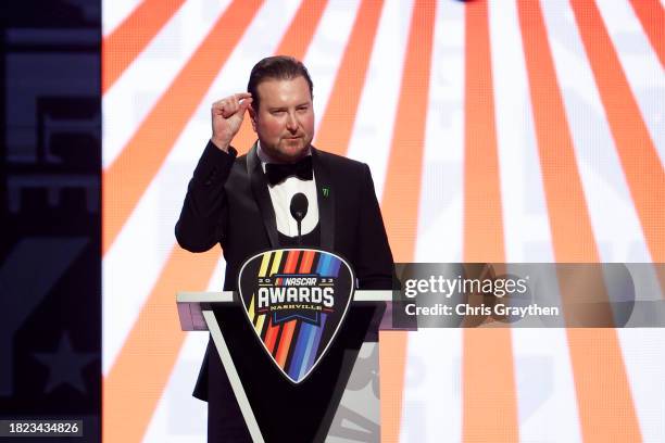 Retired NASCAR Cup Series driver Kurt Busch speaks onstage during the NASCAR Awards and Champion Celebration at the Music City Center on November 30,...