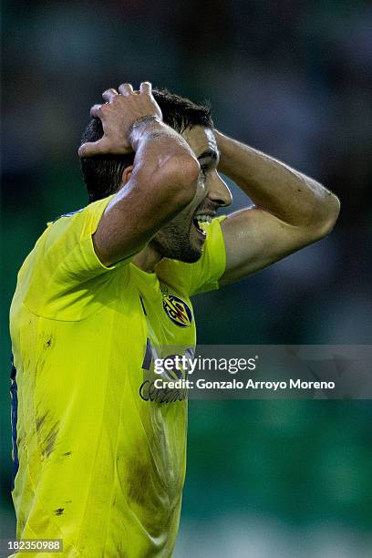 Ruben Gracia Calmache alias Cani of Villarreal CF reacts after being tackled by Lolo Reyes of Real Betis Balompie during the La Liga match between...