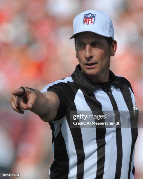 Referee Gene Steratore points to the spot of a penalty as the Tampa Bay Buccaneers play against the Arizona Cardinals September 29, 2013 at Raymond...