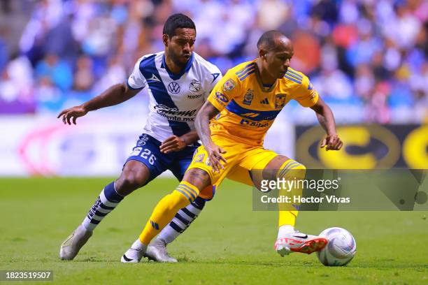 Luis Quiñones of Tigres battles for possession with Brayan Angulo of Puebla during the quarterfinals first leg match between Puebla and Tigres UANL...