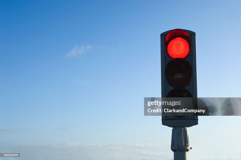 Traffic Light on Red Isolated Against Blue Sky