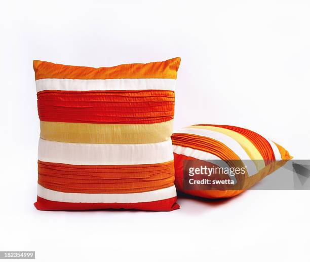 red orange and white throw pillows on a white background - cushion stockfoto's en -beelden