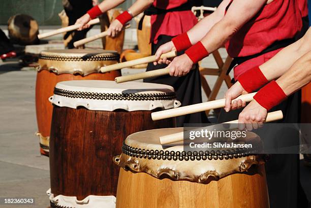 row of japanese drums and hands with sticks - slagverksinstrument bildbanksfoton och bilder