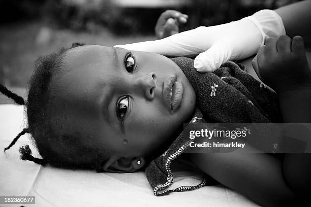 little cute girl lying an her back and crying - black and white doctor stock pictures, royalty-free photos & images
