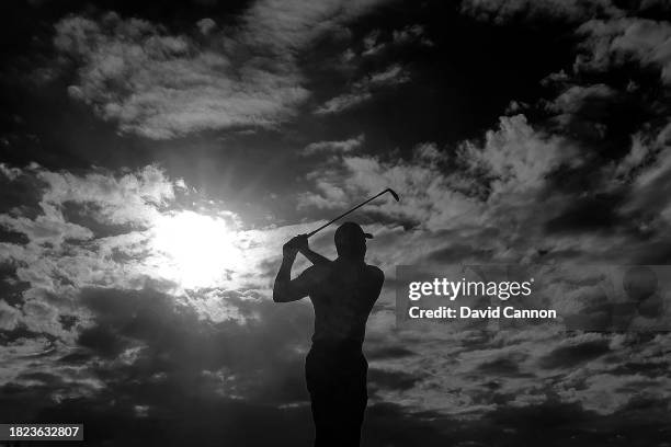 This image is a black and white conversion from an original colour file; Tiger Woods of The United States plays his second shot on the 18th hole...