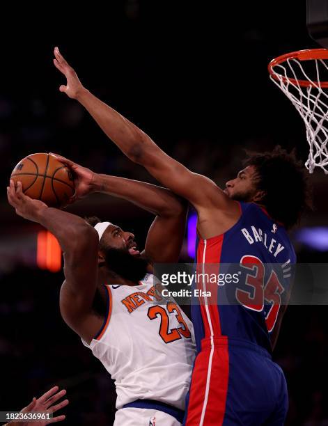 Mitchell Robinson of the New York Knicks heads for the net as Marvin Bagley III of the Detroit Pistons defends in the second quarter at Madison...