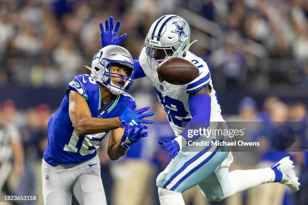 Tyler Lockett of the Seattle Seahawks attempts to complete a pass against Rashaan Evans of the Dallas Cowboys during an NFL football game between the...