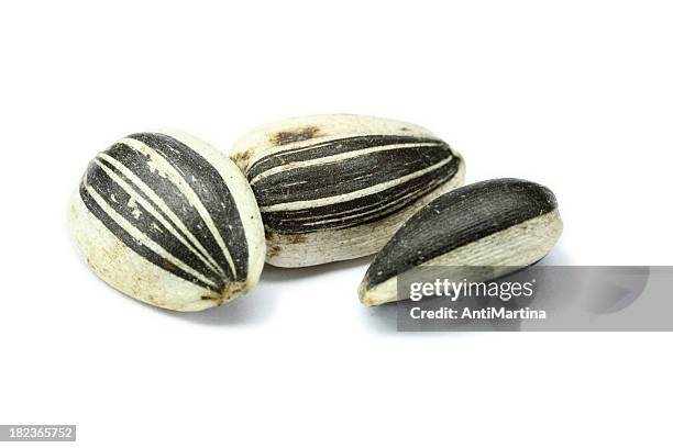 sunflower seeds isolated on white - sunflower seed stock pictures, royalty-free photos & images