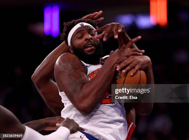 Mitchell Robinson of the New York Knicks grabs the rebound in the third quarter against the Detroit Pistons at Madison Square Garden on November 30,...