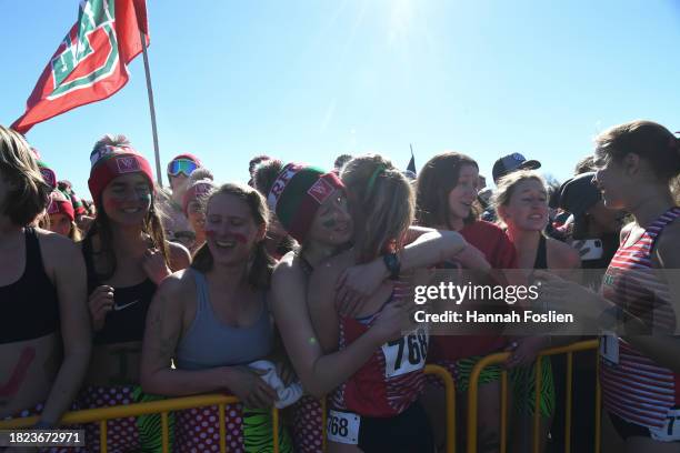 Abigail Patterson of the Washington St Louis Bears hugs her teammates during the Division III Men's and Women's Cross Country Championship held at...