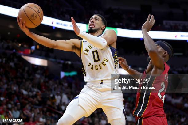 Tyrese Haliburton of the Indiana Pacers shoots the ball past Jimmy Butler of the Miami Heat during the third quarter of the game at Kaseya Center on...