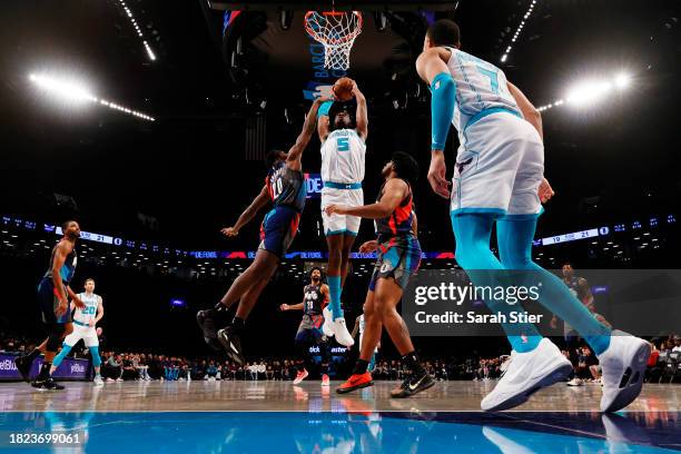 Mark Williams of the Charlotte Hornets goes to the basket as Day'Ron Sharpe and Cam Thomas of the Brooklyn Nets defend during the game at Barclays...
