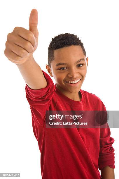 africian abstammung teenager junge gestikulieren daumen hoch - black thumbs up white background stock-fotos und bilder