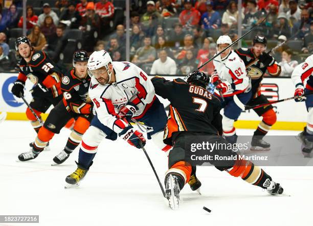 Alex Ovechkin of the Washington Capitals skates the puck against Radko Gudas of the Anaheim Ducks in the first period at Honda Center on November 30,...