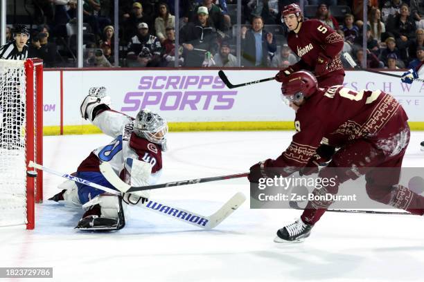 Alexandar Georgiev of the Colorado Avalanche makes a save against Clayton Keller of the Arizona Coyotes during the second period at Mullett Arena on...