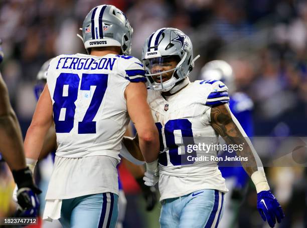 Running back Tony Pollard of the Dallas Cowboys is congratulated by tight end Jake Ferguson after scoring a touchdown during the 3rd quarter of the...