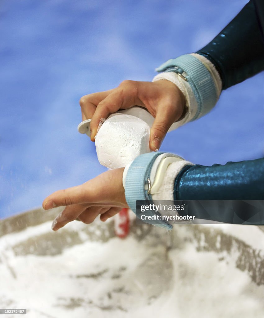 Female gymnist chalking hands