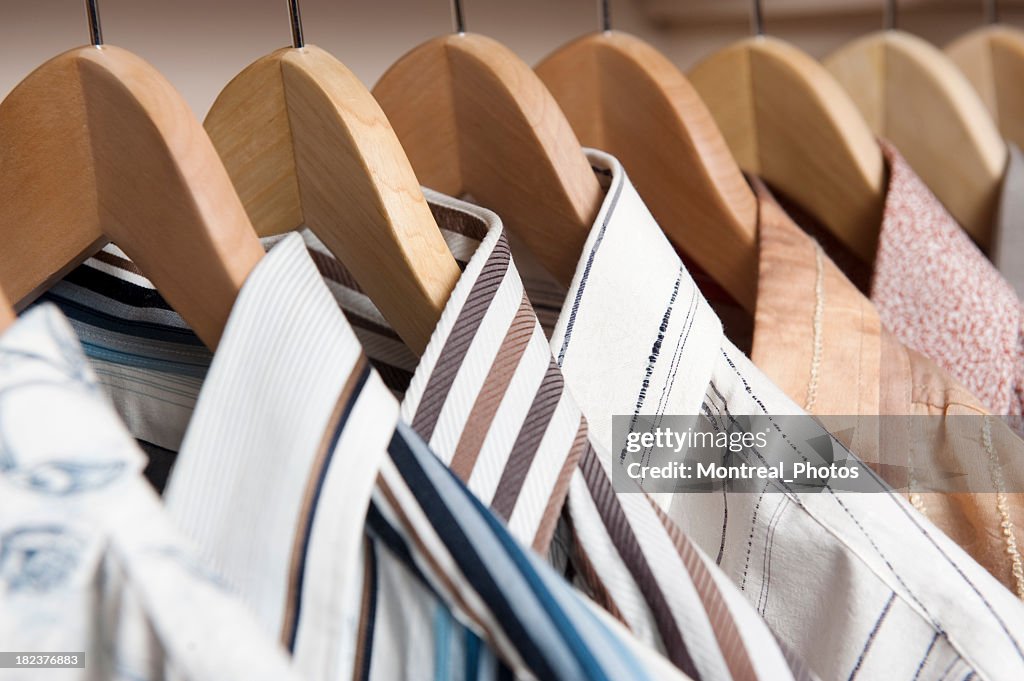 Shirts hanging on wooden coat hangers