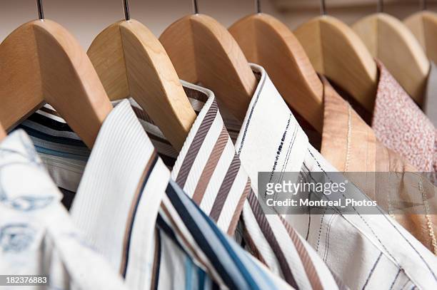 shirts hanging on wooden coat hangers - all shirts stock pictures, royalty-free photos & images