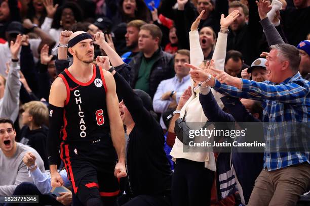 Alex Caruso of the Chicago Bulls celebrates a three-pointer at the end of regulation in the game against the Milwaukee Bucks at the United Center on...