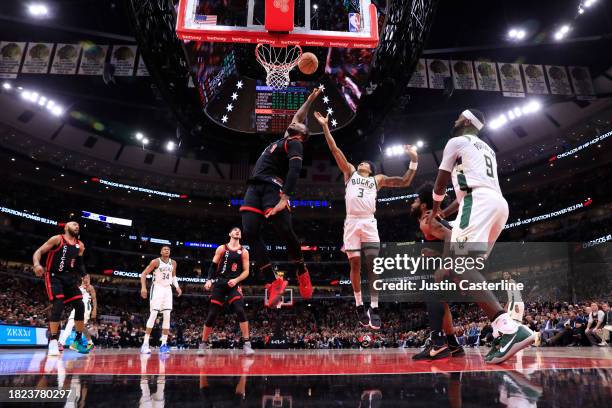 Andre Drummond of the Chicago Bulls rebounds the ball over MarJon Beauchamp of the Milwaukee Bucks during the second half at the United Center on...