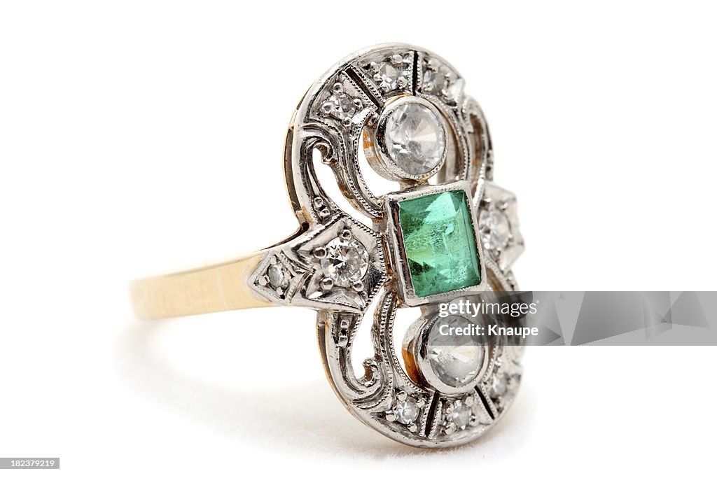 Old Gold Ring with Emerald and Diamonds on White Background