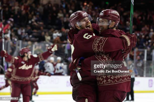 Lawson Crouse of the Arizona Coyotes celebrates with the game winning goal scorer Nick Bjugstad of the Arizona Coyotes against the Colorado Avalanche...