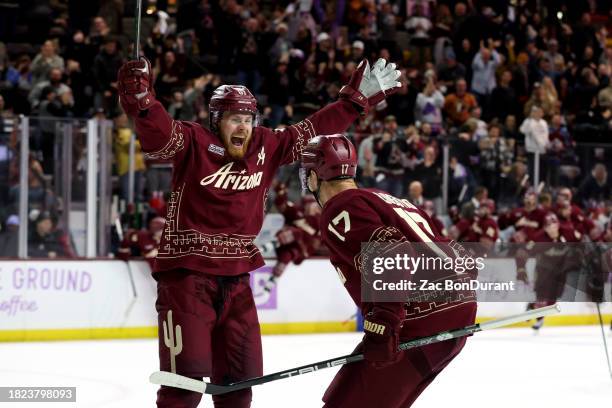 Lawson Crouse of the Arizona Coyotes celebrates with the game winning goal scorer Nick Bjugstad of the Arizona Coyotes against the Colorado Avalanche...