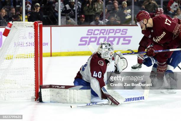 Nick Bjugstad of the Arizona Coyotes scores the game winning goal against Alexandar Georgiev of the Colorado Avalanche during the overtime period at...