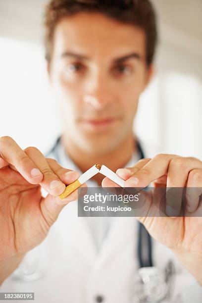 medical practitioner breaking a cigarette - broken cigarette stock pictures, royalty-free photos & images