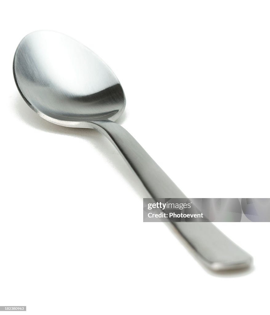 Silver spoon against white background 
