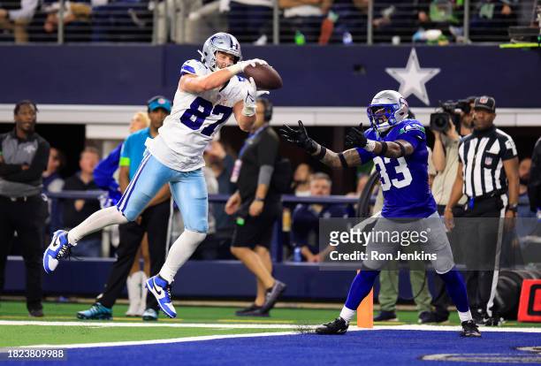 Tight end Jake Ferguson of the Dallas Cowboys makes a catch in the end-zone as safety Jamal Adams of the Seattle Seahawks defends during the 4th...